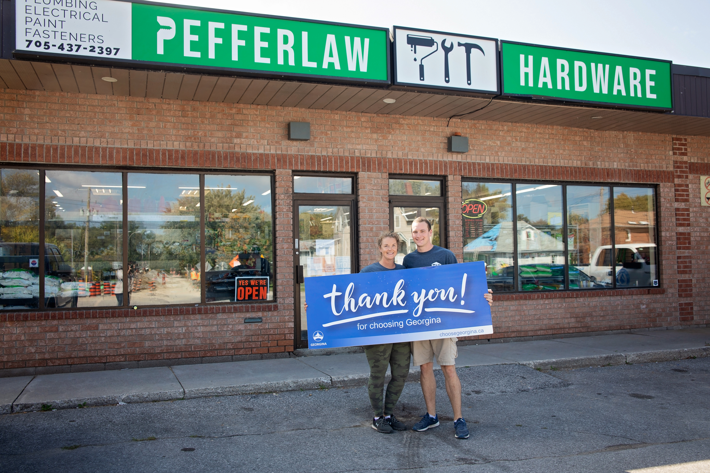 Pefferlaw Hardware owners standing outside store