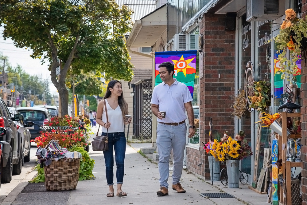 male and female walking in front of a store in a busy downtown area