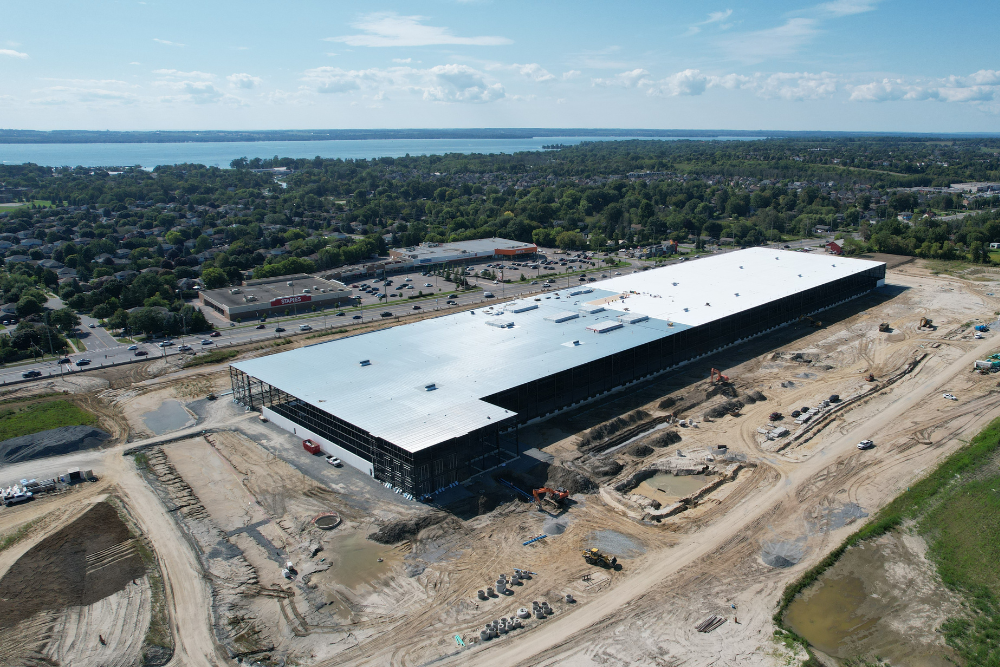 large industrial building development with lake in background