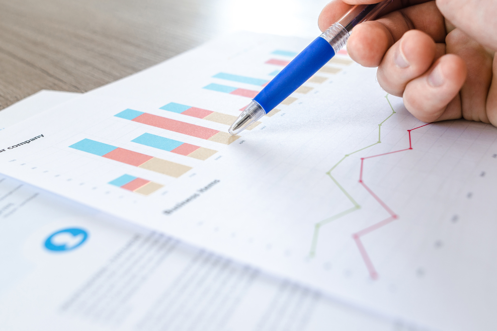 pen on paper with graphs and charts