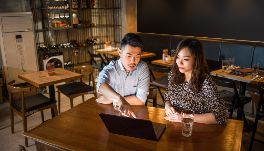 adults looking at computer