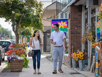 male and female walking in front of a store in a busy downtown area