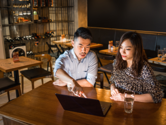 adults looking at computer